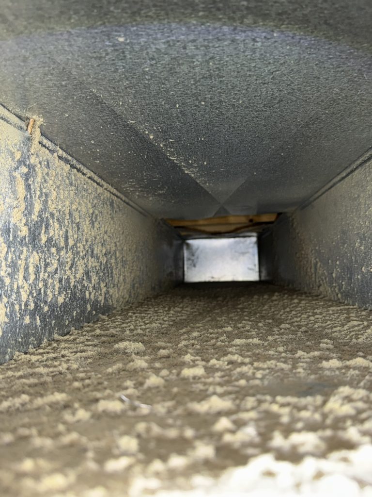 Before photo showing dust buildup inside residential ductwork in Troy, Michigan