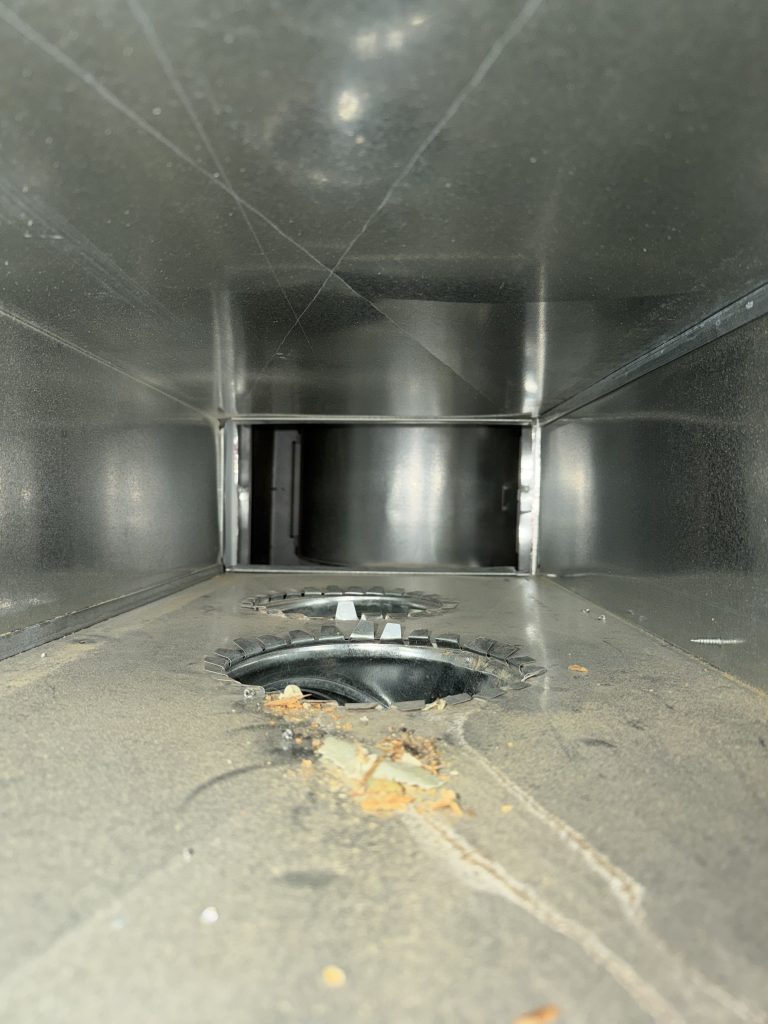 Before duct cleaning photo showing debris inside a home’s ductwork